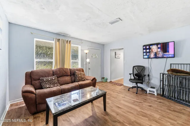 a living room with furniture and a flat screen tv