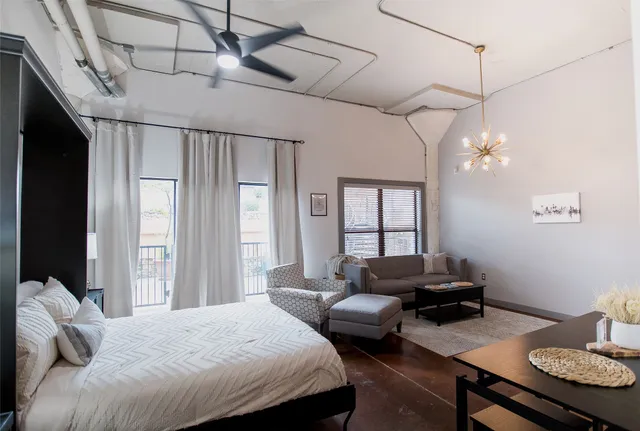 a bedroom with a bed window and couch