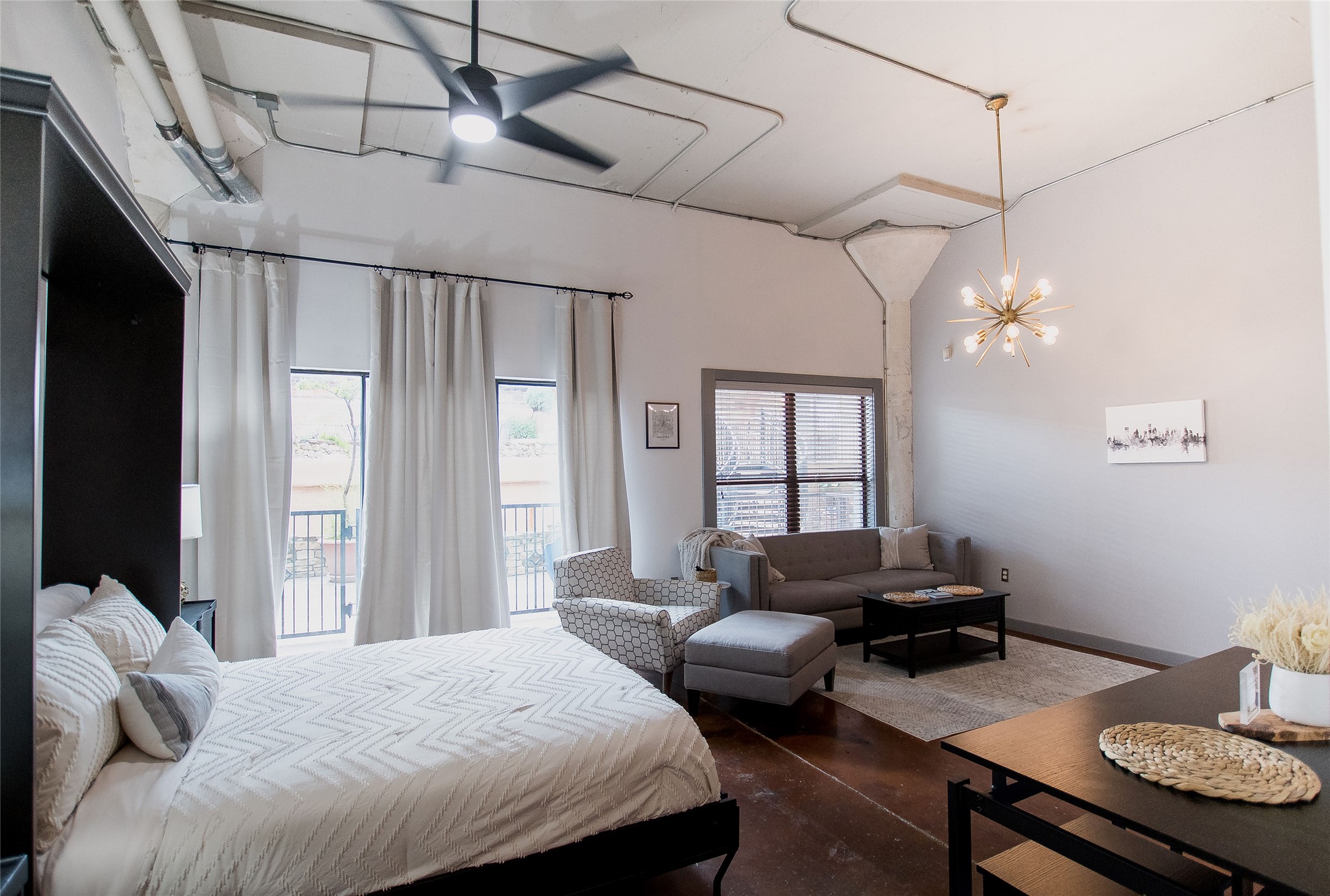 a bedroom with a bed window and couch