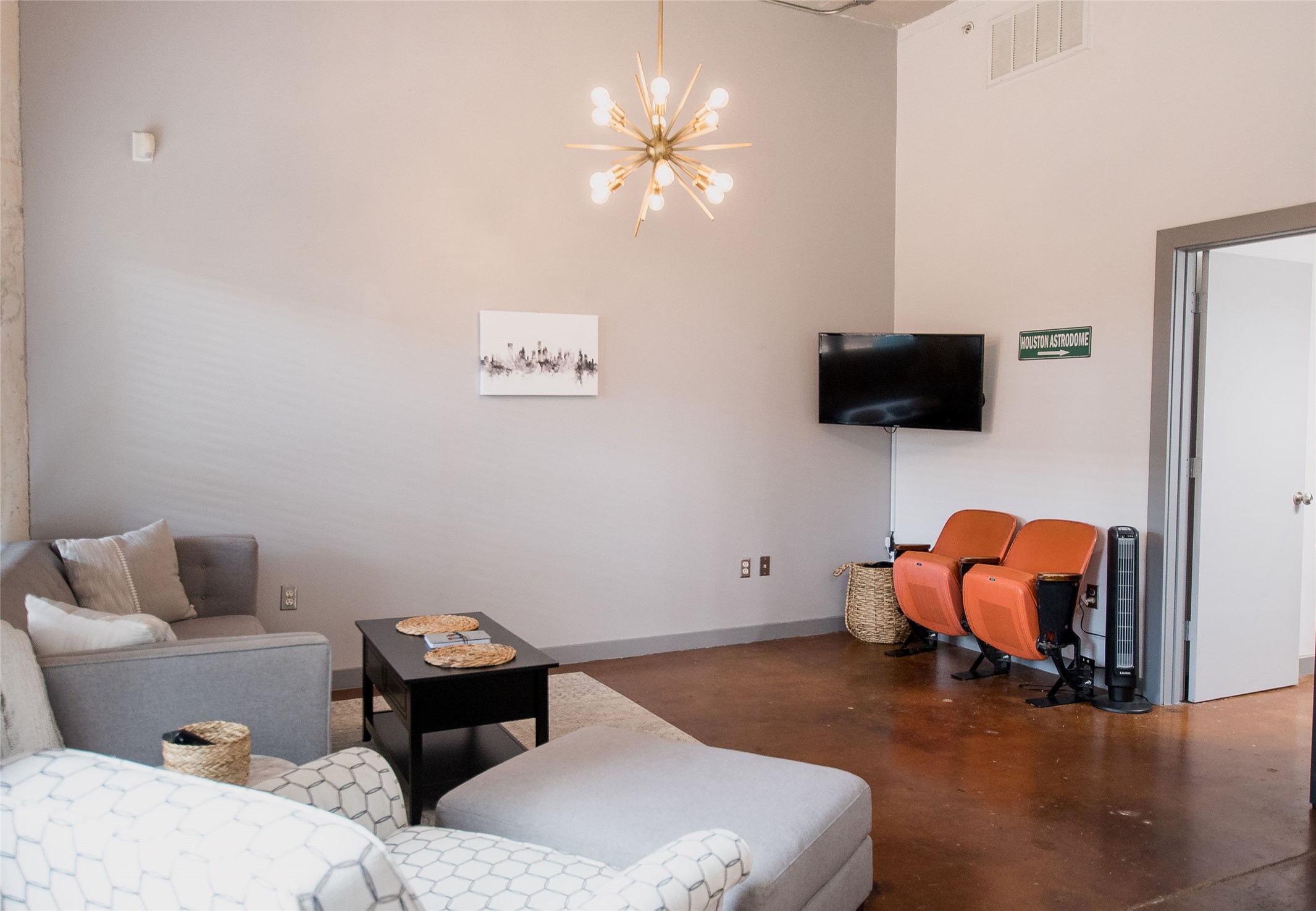 2205 McKinney Street, Unit 309 Houston, TX 77003 - Photo 11 of 14 a living room with furniture and a flat screen tv
