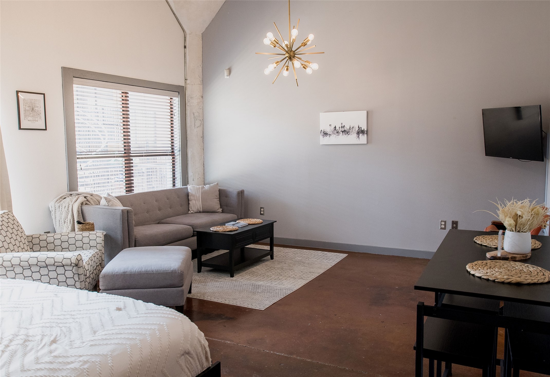 2205 McKinney Street, Unit 309 Houston, TX 77003 - Photo 5 of 14 a living room with furniture a chandelier and a window