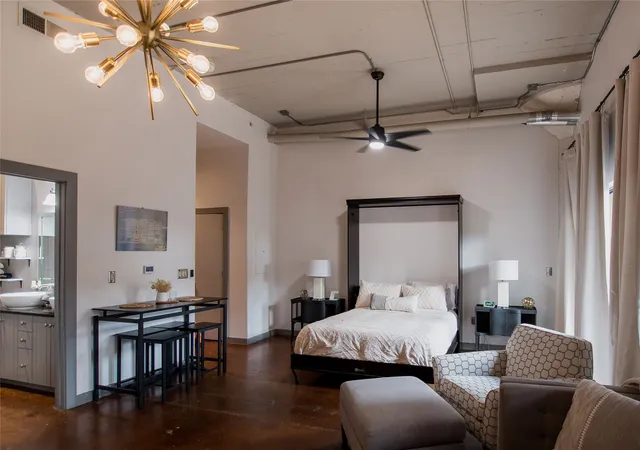 a bedroom with furniture and wooden floor