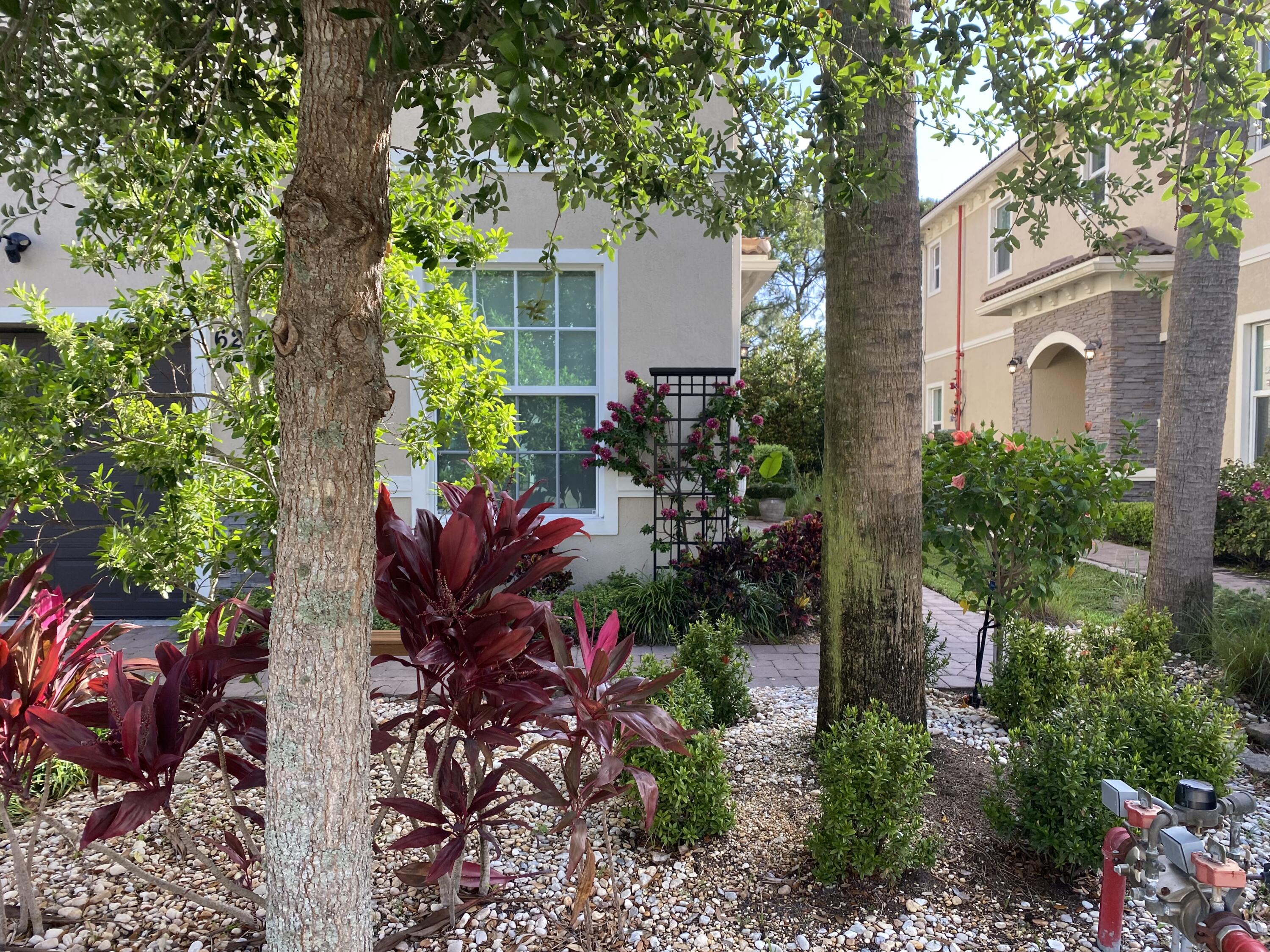 Undisclosed Address Hobe Sound, FL 33455 - Photo 1 of 20 a view of a house with a garden