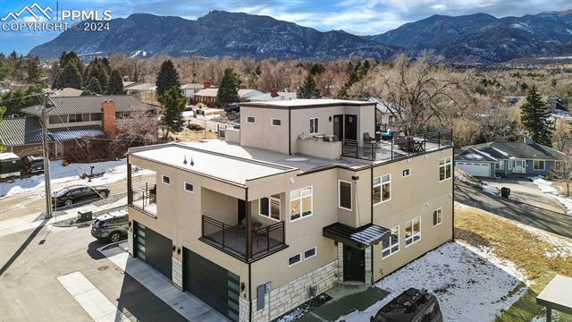 74 Sommerlyn Road Colorado Springs, CO 80906 - Photo 2 of 32 Snowy aerial view with a mountain view