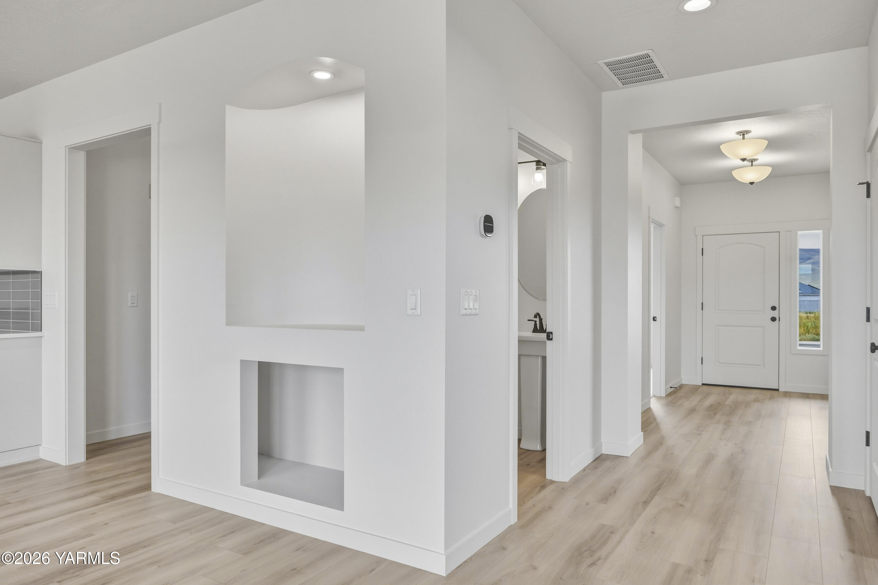 215 Packer Street Prosser, WA 99350 - Photo 39 of 45 a view of a hallway with wooden floor and a cabinet