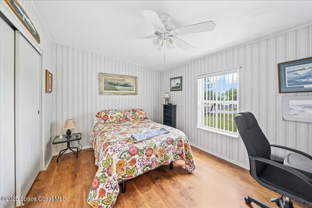 a bedroom with a bed and a large window