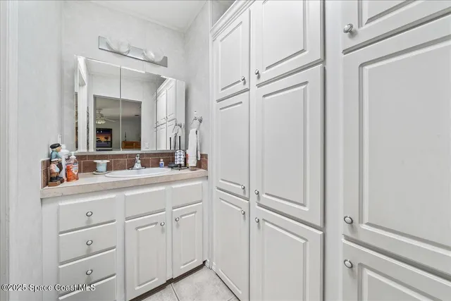 a bathroom with a shower sink and mirror