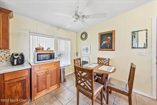 a view of a dining room with furniture and a kitchen