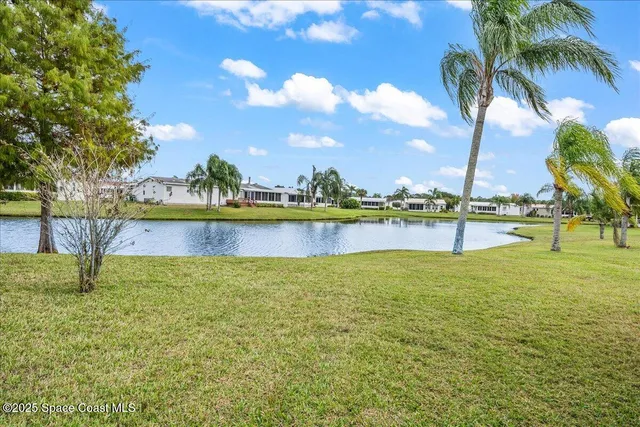 a view of a lake with houses in the back