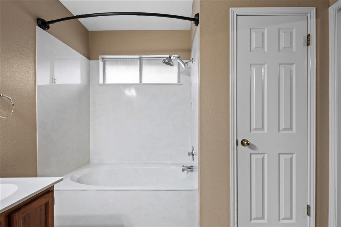 13438 Moscow Trail Austin, TX 78729 - Photo 24 of 40 Bathroom with vanity and bathtub / shower combination