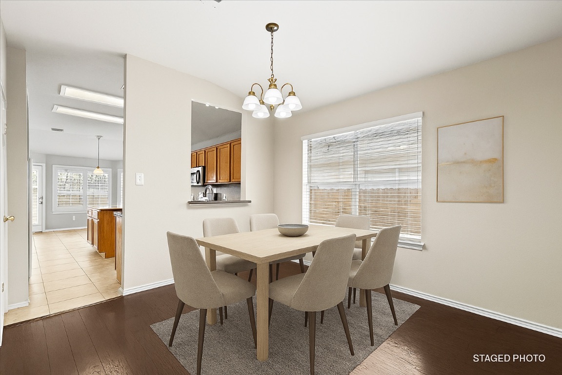 13438 Moscow Trail Austin, TX 78729 - Photo 3 of 40 Virtually Staged
Dining area with a chandelier, hardwood / wood-style flooring, and lofted ceiling
