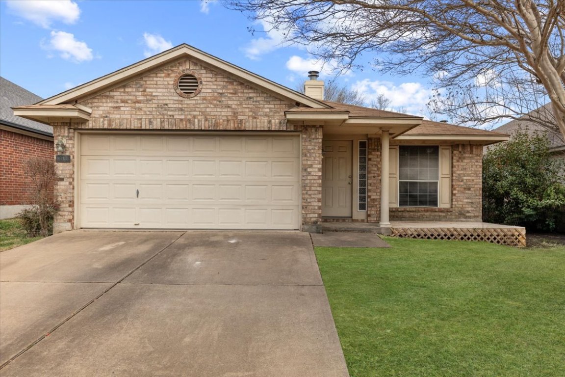 13438 Moscow Trail Austin, TX 78729 - Photo 6 of 40 Ranch-style house featuring concrete driveway, a chimney, brick siding, a front lawn, and an attached garage