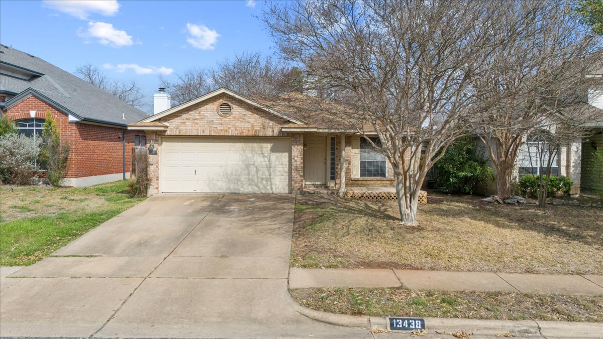 13438 Moscow Trail Austin, TX 78729 - Photo 9 of 40 View of front facade featuring a garage, concrete driveway, and brick siding