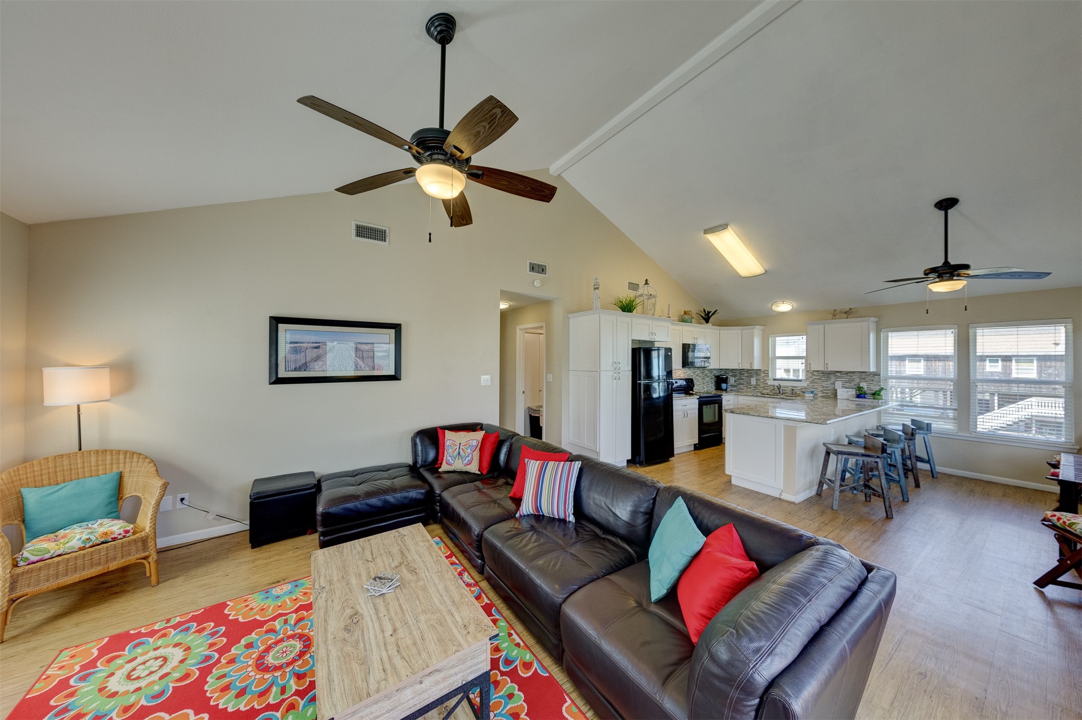23005 Fresca Street Galveston, TX 77554 - Photo 11 of 37 a living room with furniture kitchen view and a wooden floor