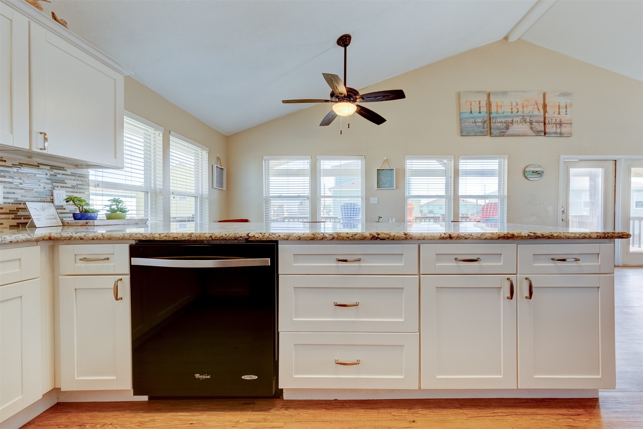 23005 Fresca Street Galveston, TX 77554 - Photo 15 of 37 a kitchen with white cabinets and appliances
