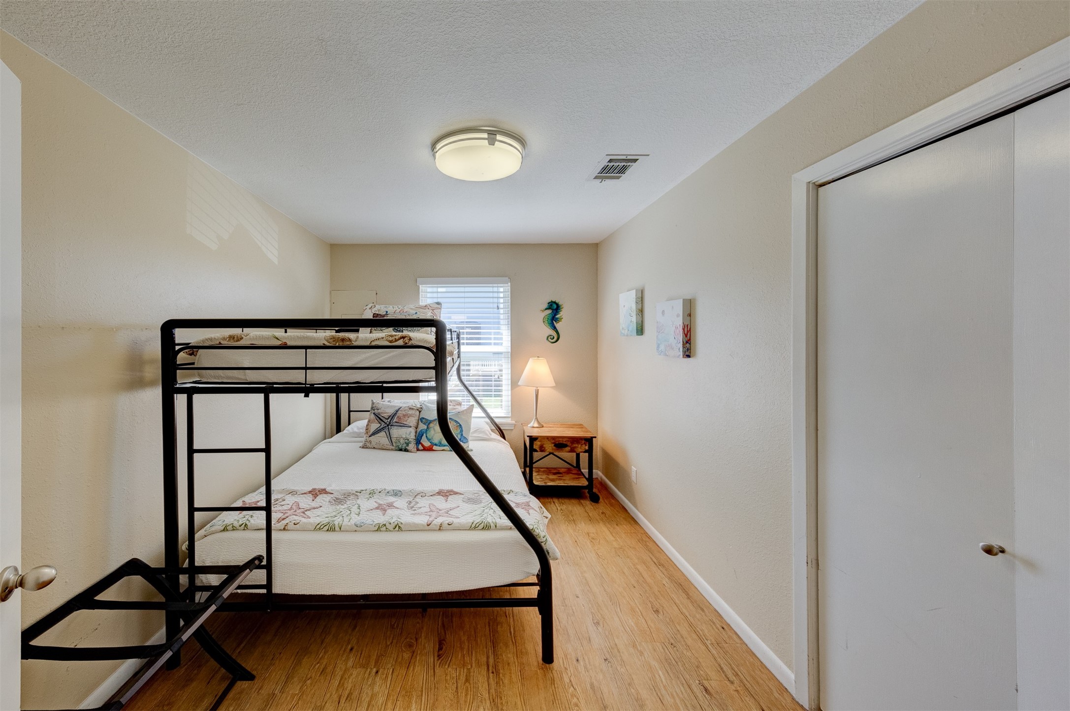 23005 Fresca Street Galveston, TX 77554 - Photo 20 of 37 a view of a bedroom with furniture and wooden floor