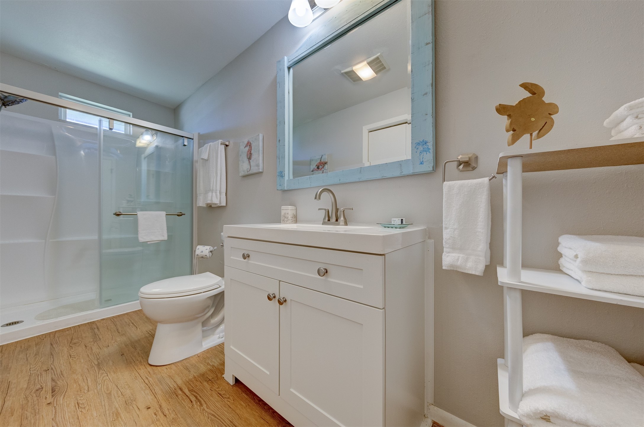 23005 Fresca Street Galveston, TX 77554 - Photo 22 of 37 a bathroom with a granite countertop toilet sink and a mirror