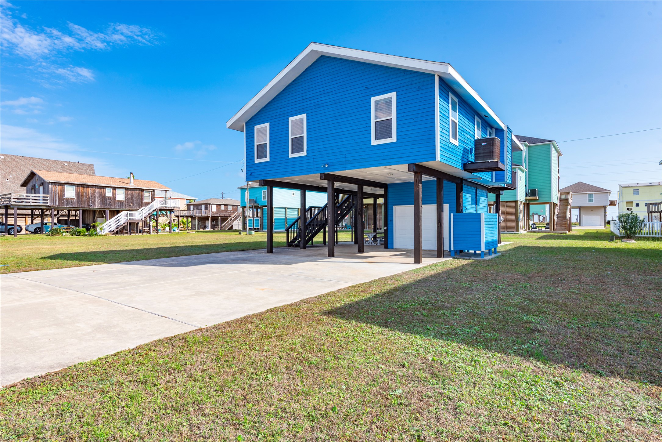 23005 Fresca Street Galveston, TX 77554 - Photo 24 of 37 a front view of a house with a yard