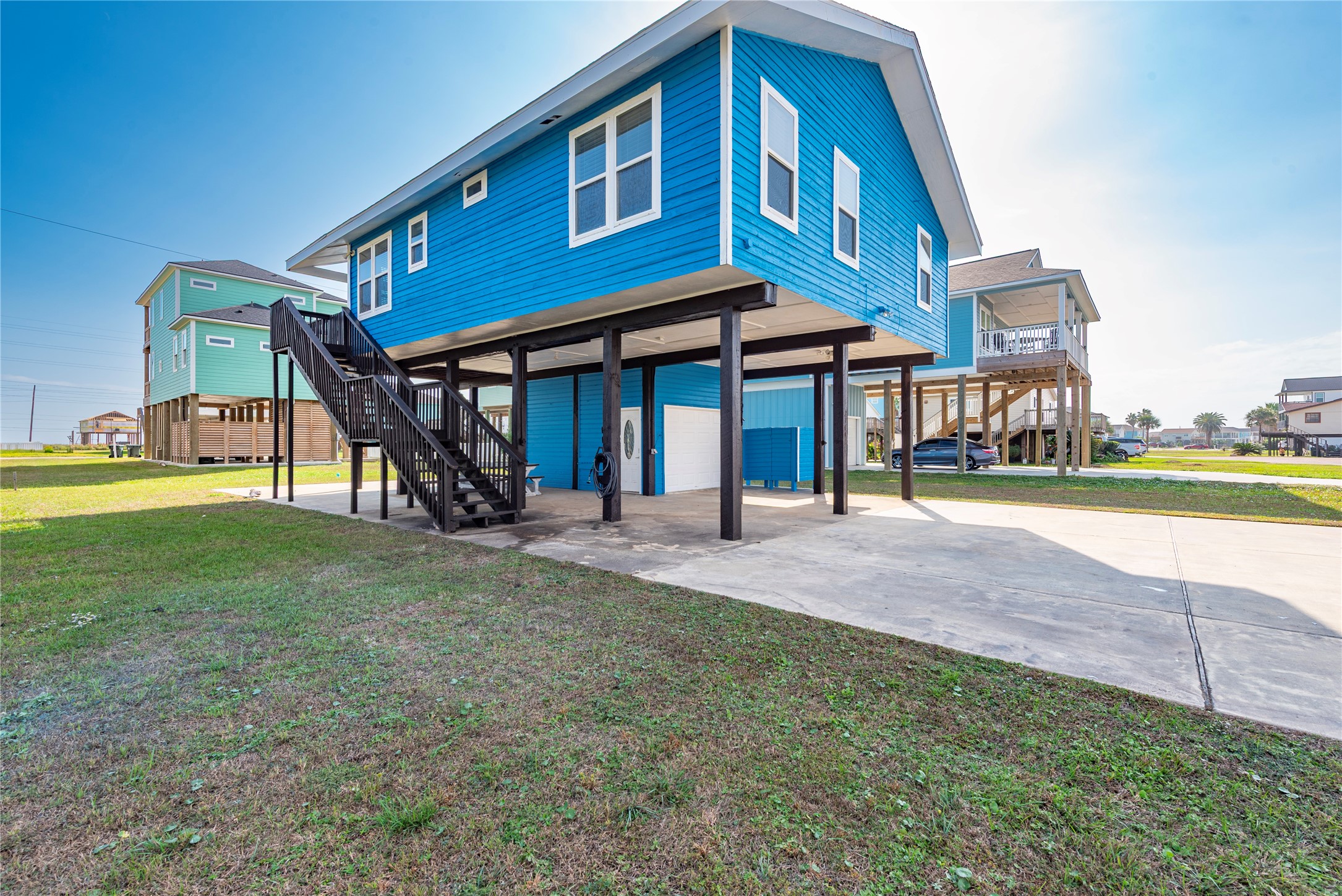 23005 Fresca Street Galveston, TX 77554 - Photo 4 of 37 a front view of a house with a yard