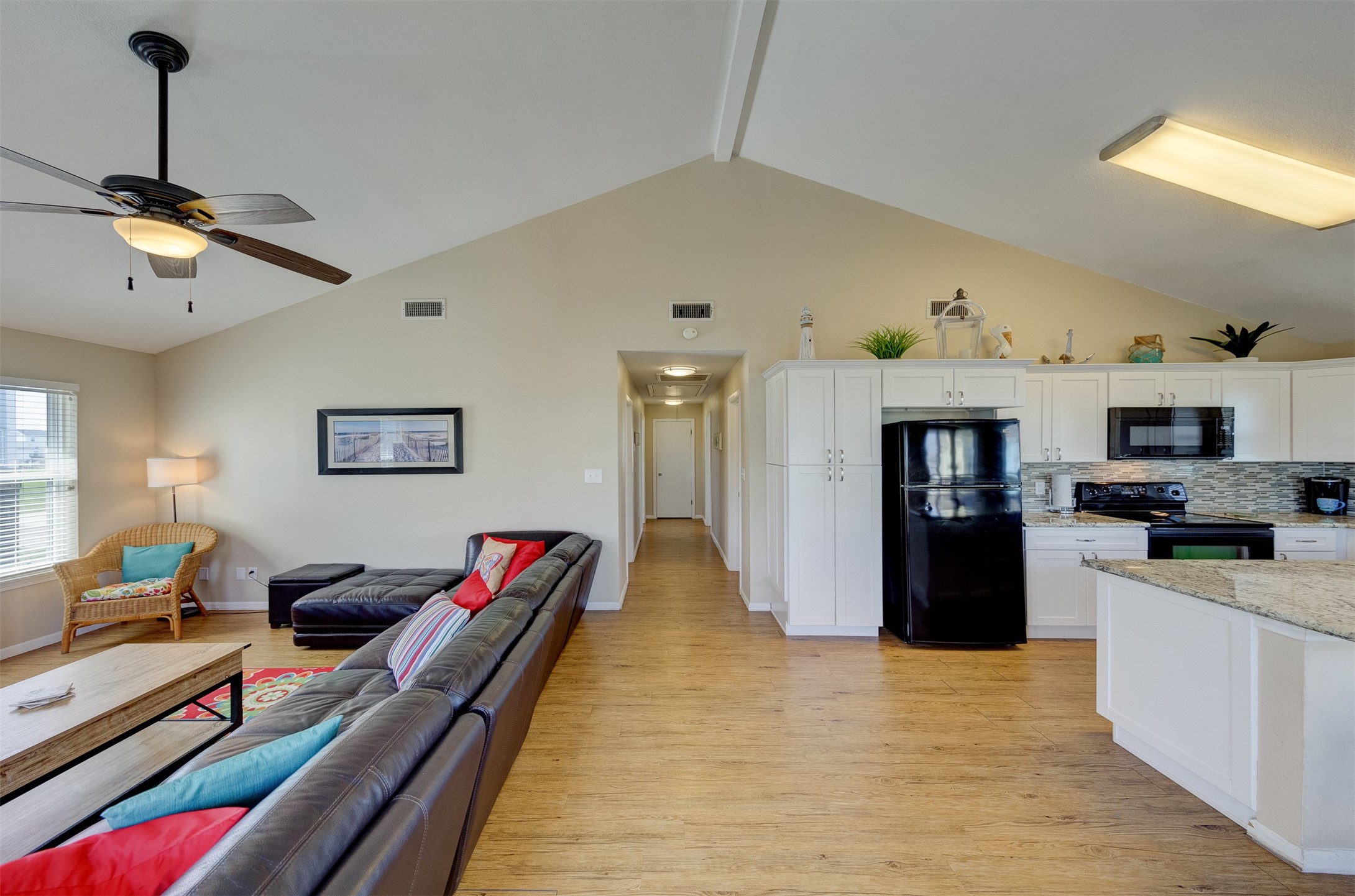 23005 Fresca Street Galveston, TX 77554 - Photo 10 of 37 a living room with furniture flat screen tv and kitchen view