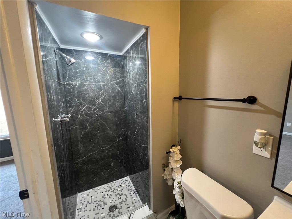 7475 Selwick Drive Parma, OH 44129 - Photo 16 of 29 Bathroom with tiled shower and toilet