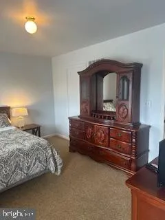 a bedroom with a bed and a dresser