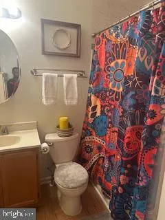 a white toilet sitting next to a bathroom sink