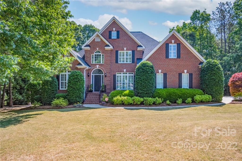 front view of a house next to a yard