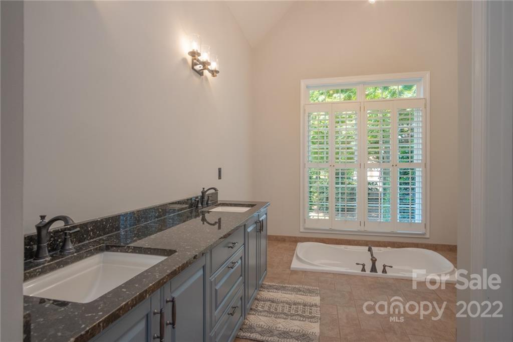2900 Sliding Rock Trail Fort Mill, SC 29708 - Photo 16 of 41 a bathroom with a granite countertop sink and a bathtub