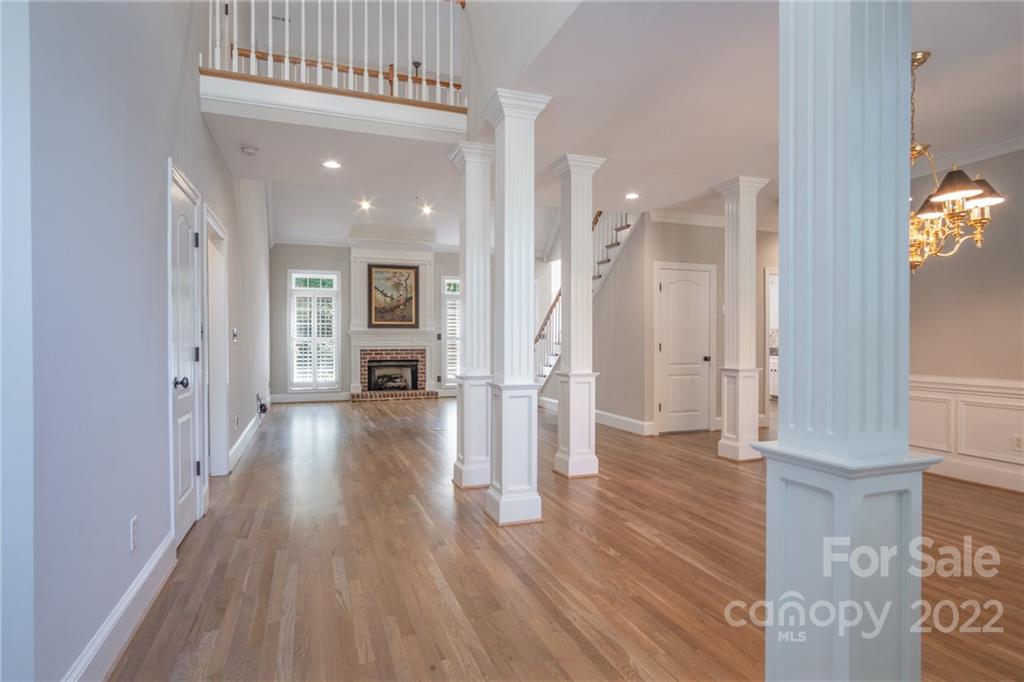 2900 Sliding Rock Trail Fort Mill, SC 29708 - Photo 6 of 41 a view of a hallway with wooden floor fireplace and windows