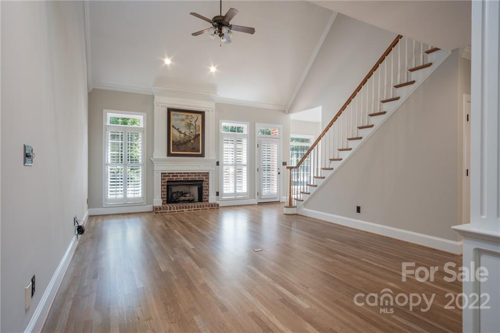 2900 Sliding Rock Trail Fort Mill, SC 29708 - Photo 8 of 41 a view of an empty room with wooden floor fireplace and a window