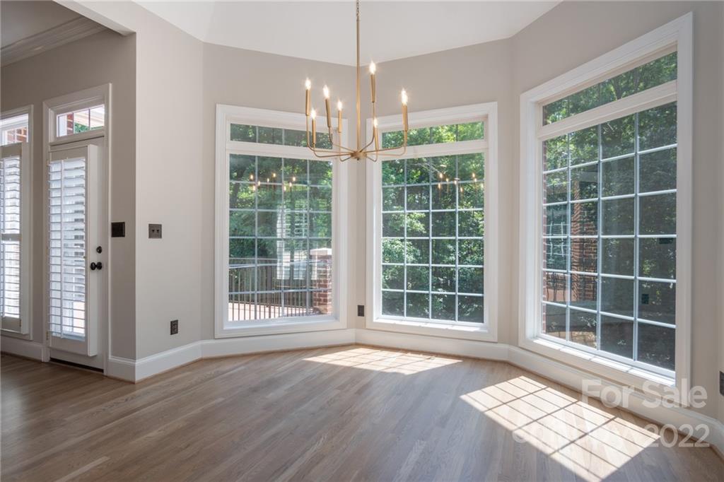 2900 Sliding Rock Trail Fort Mill, SC 29708 - Photo 10 of 41 a view of an empty room with wooden floor and windows