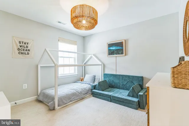 a living room with a couch and a chandelier