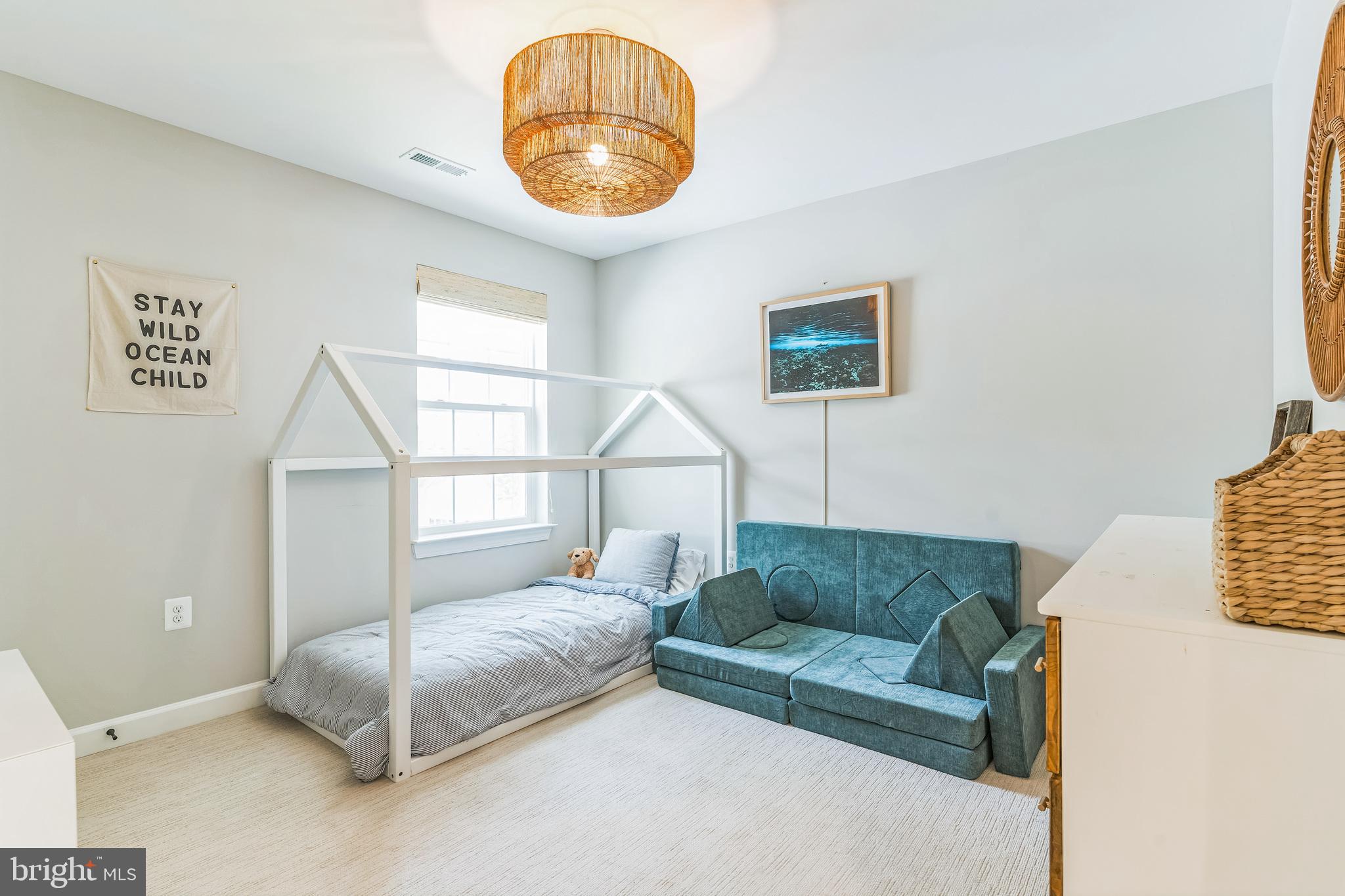 14720 Locust Court Issue, MD 20645 - Photo 20 of 41 a living room with a couch and a chandelier