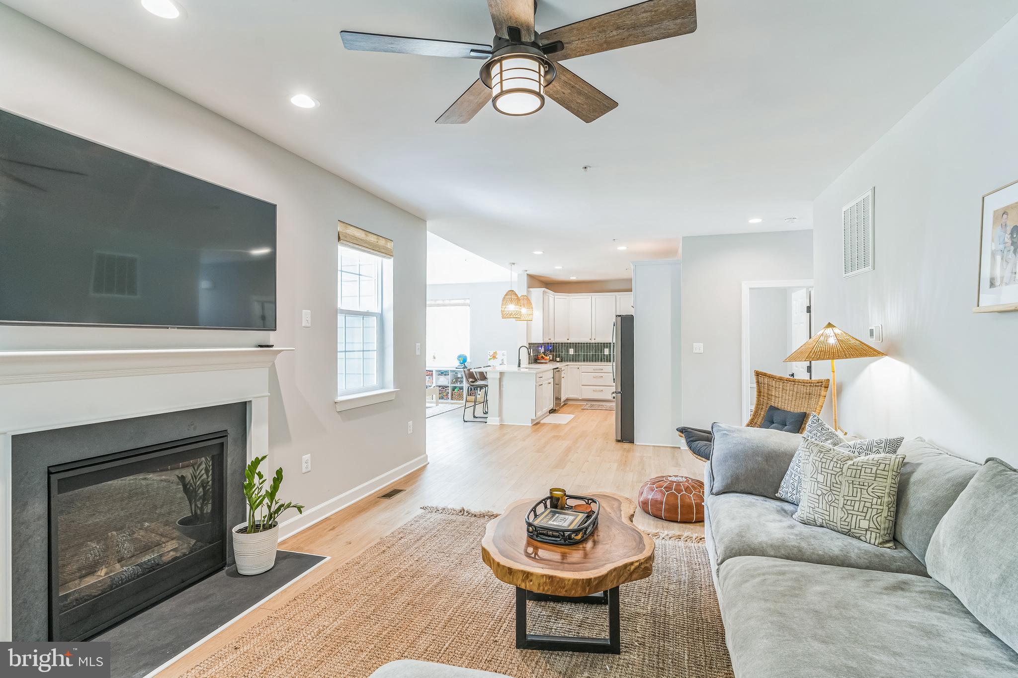 14720 Locust Court Issue, MD 20645 - Photo 6 of 41 a living room with furniture a fireplace and a flat screen tv