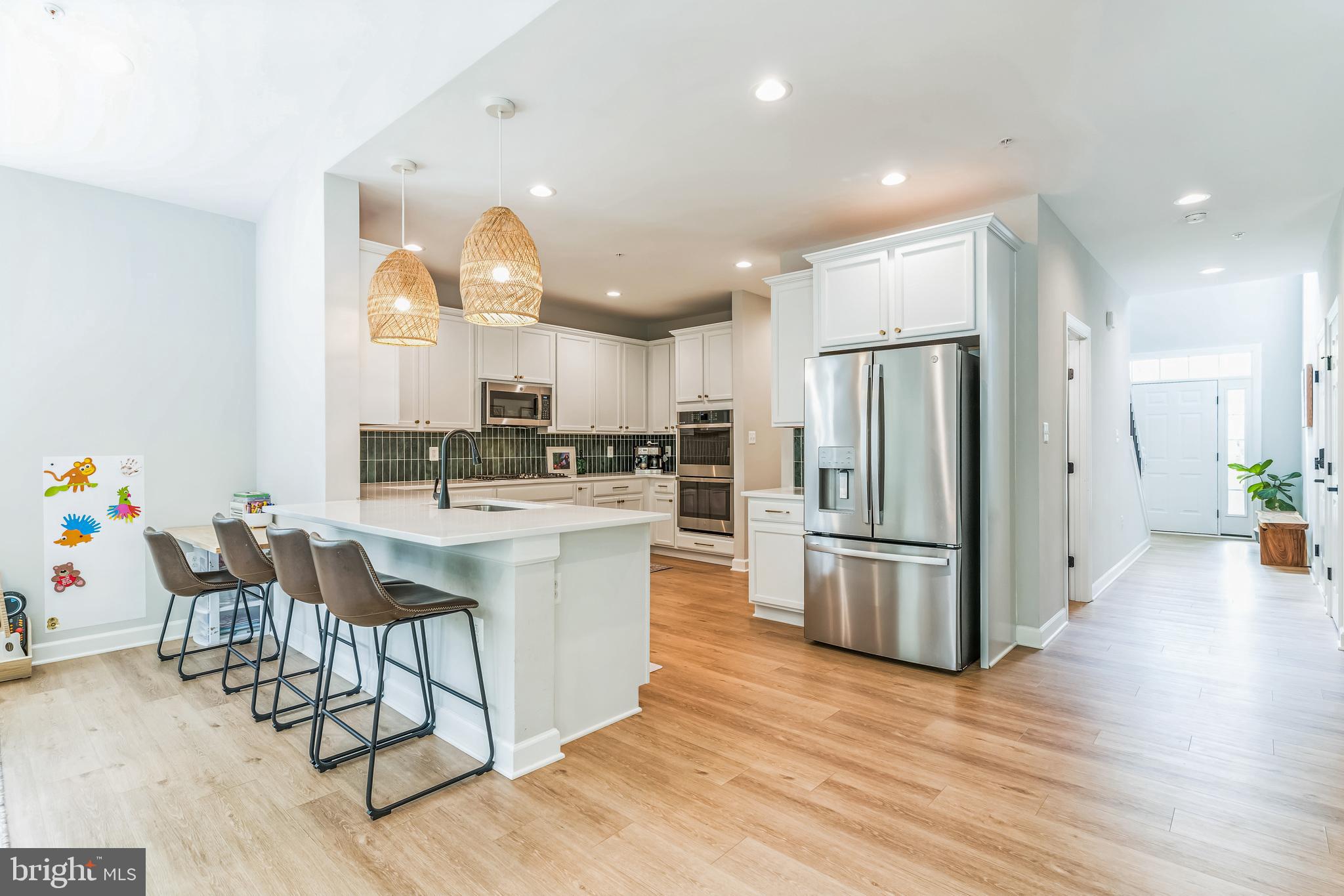 14720 Locust Court Issue, MD 20645 - Photo 9 of 41 a kitchen with stainless steel appliances granite countertop a refrigerator oven a stove top oven a sink dishwasher and white cabinets with wooden floor