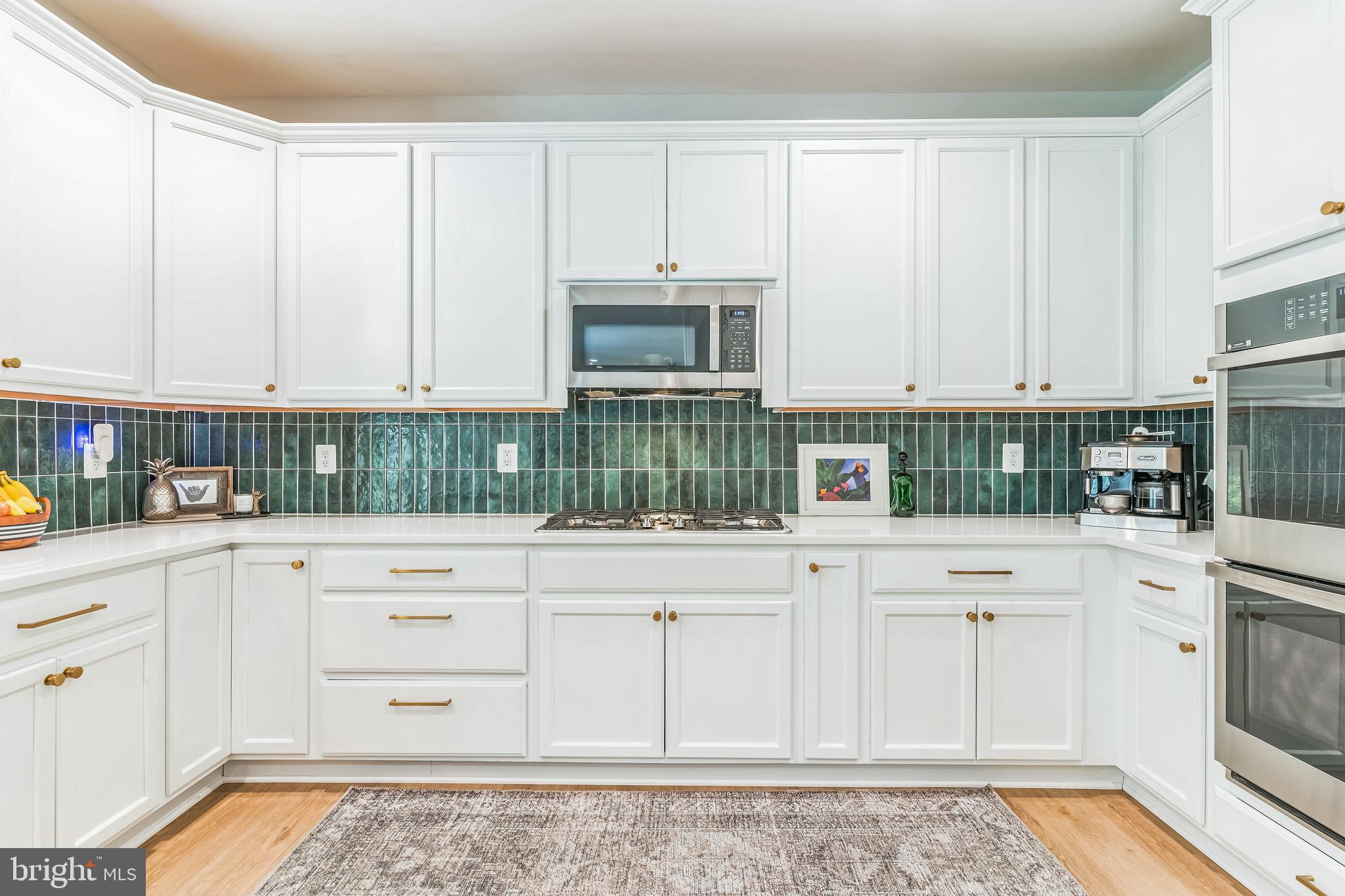 14720 Locust Court Issue, MD 20645 - Photo 10 of 41 a kitchen with stainless steel appliances granite countertop a stove a sink and a white cabinets