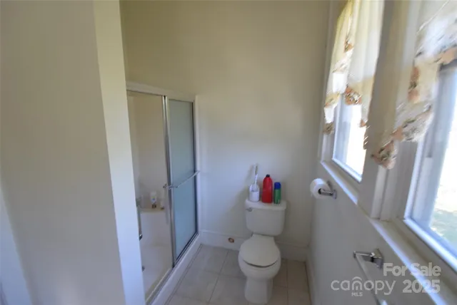 a view of a hallway with wooden floor and stairs