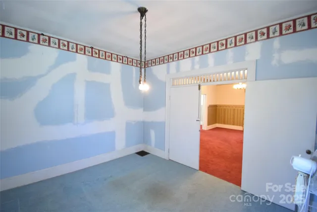 a view of a room with window & a ceiling fan