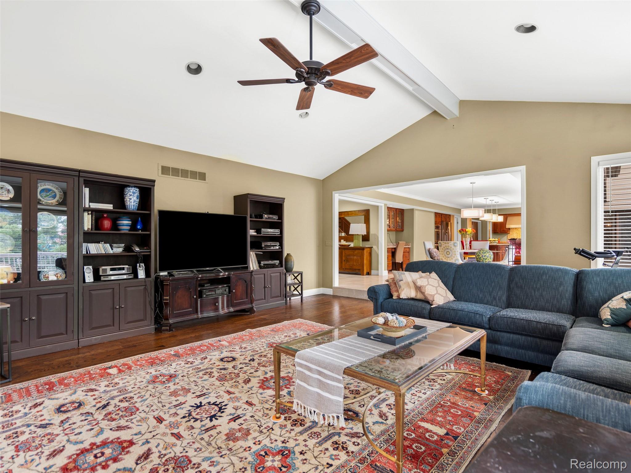 5724 Murfield Drive Rochester, MI 48306 - Photo 62 of 99 Living room featuring wood finished floors, a ceiling fan, and a chandelier