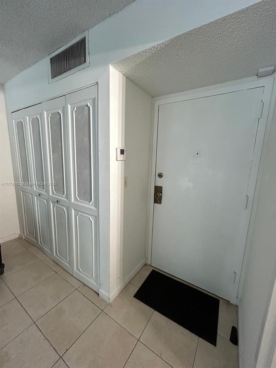 17021 North Bay Road, Unit 322 Sunny Isles Beach, FL 33160 - Photo 11 of 18 a view of a closet area with an empty room