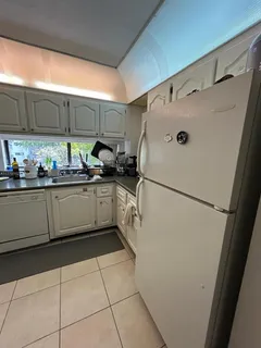 a kitchen with cabinets and appliances