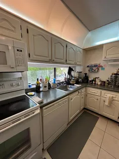 a large hall with wooden floor and a rug
