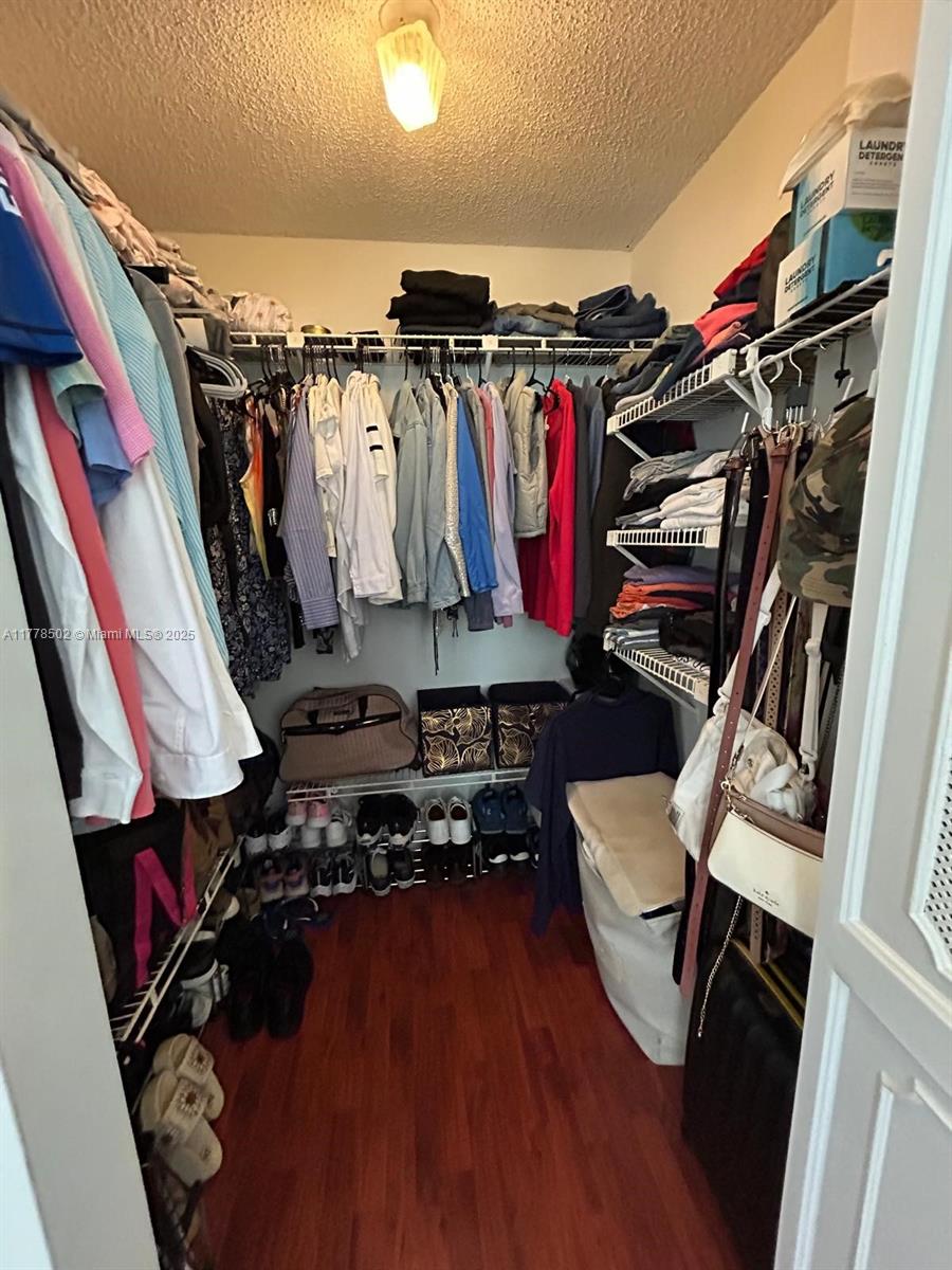 17021 North Bay Road, Unit 322 Sunny Isles Beach, FL 33160 - Photo 15 of 18 a view of walk in closet with clothes and shoes