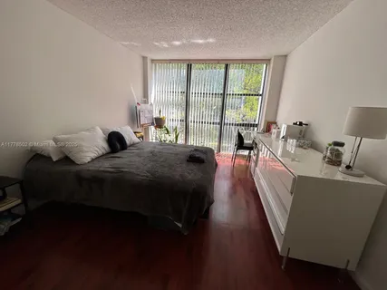 a view of a livingroom with furniture and floor to ceiling window