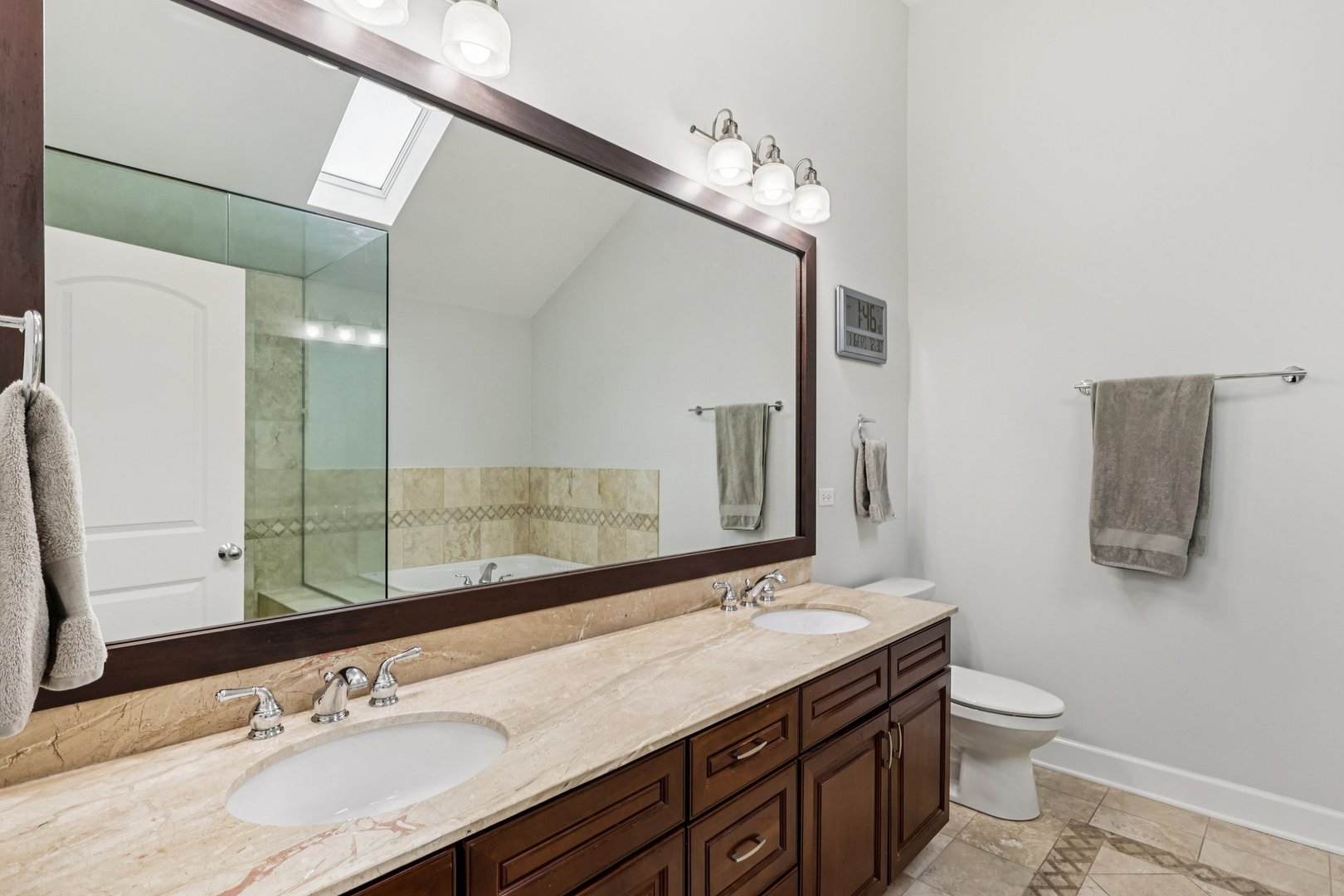 3137 North Spaulding Avenue Chicago, IL 60618 - Photo 15 of 42 a bathroom with a granite countertop double vanity sink and a mirror