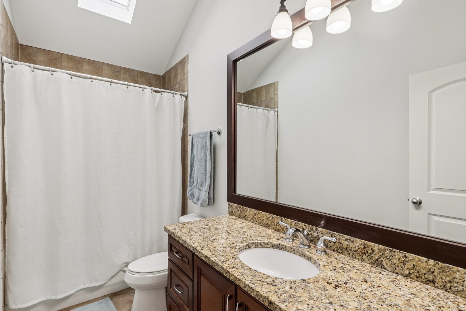 3137 North Spaulding Avenue Chicago, IL 60618 - Photo 23 of 42 a bathroom with a granite countertop sink and a mirror