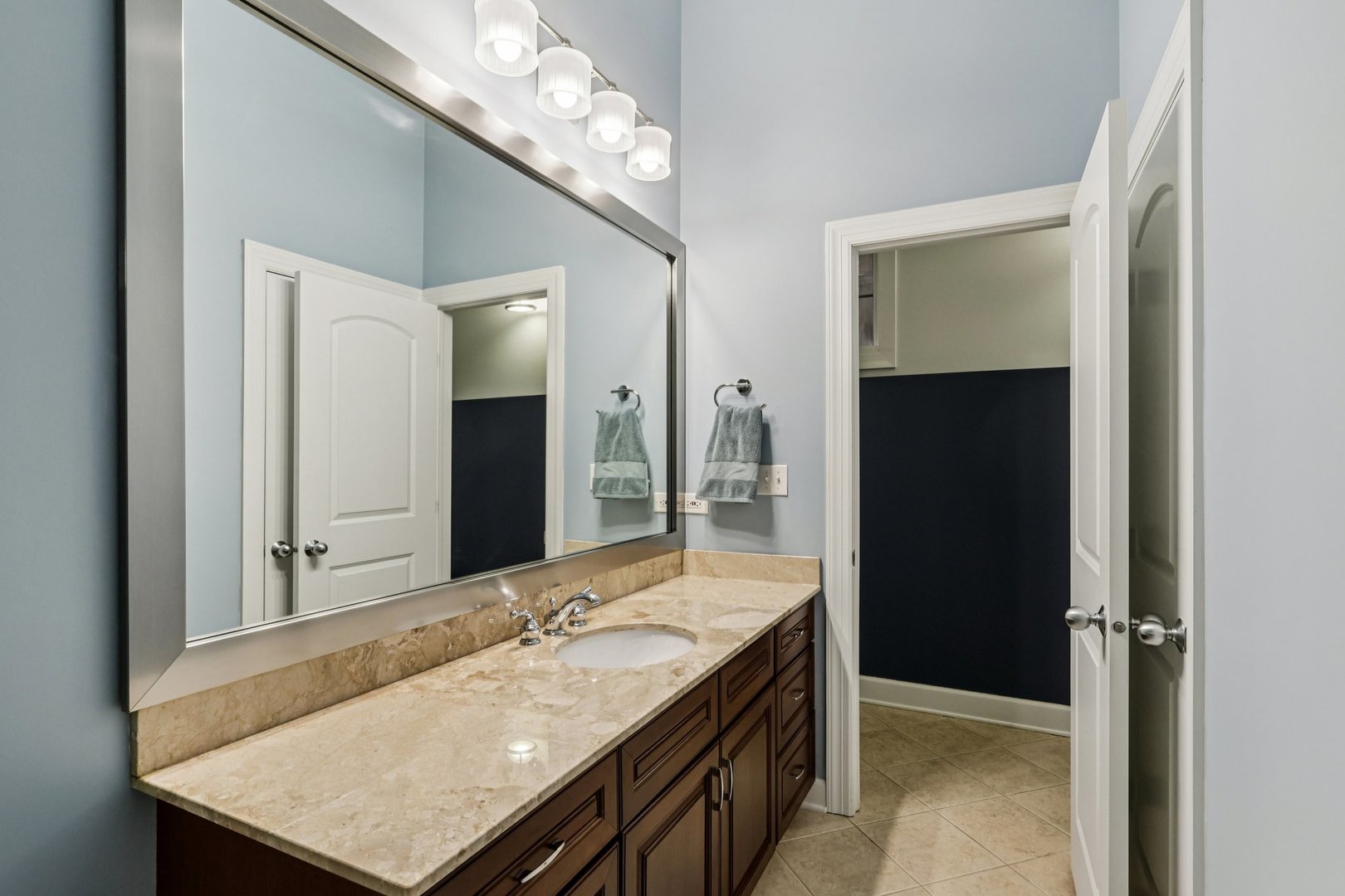 3137 North Spaulding Avenue Chicago, IL 60618 - Photo 30 of 42 a bathroom with a granite countertop sink and a mirror