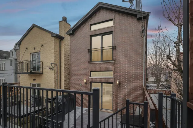 a view of a house with wooden fence