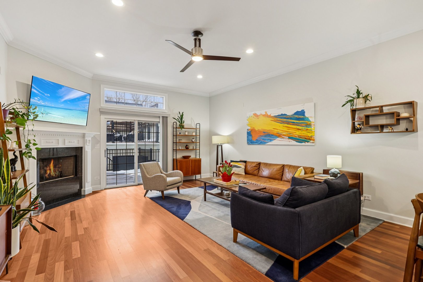 3137 North Spaulding Avenue Chicago, IL 60618 - Photo 9 of 42 a living room with furniture a fireplace and a flat screen tv